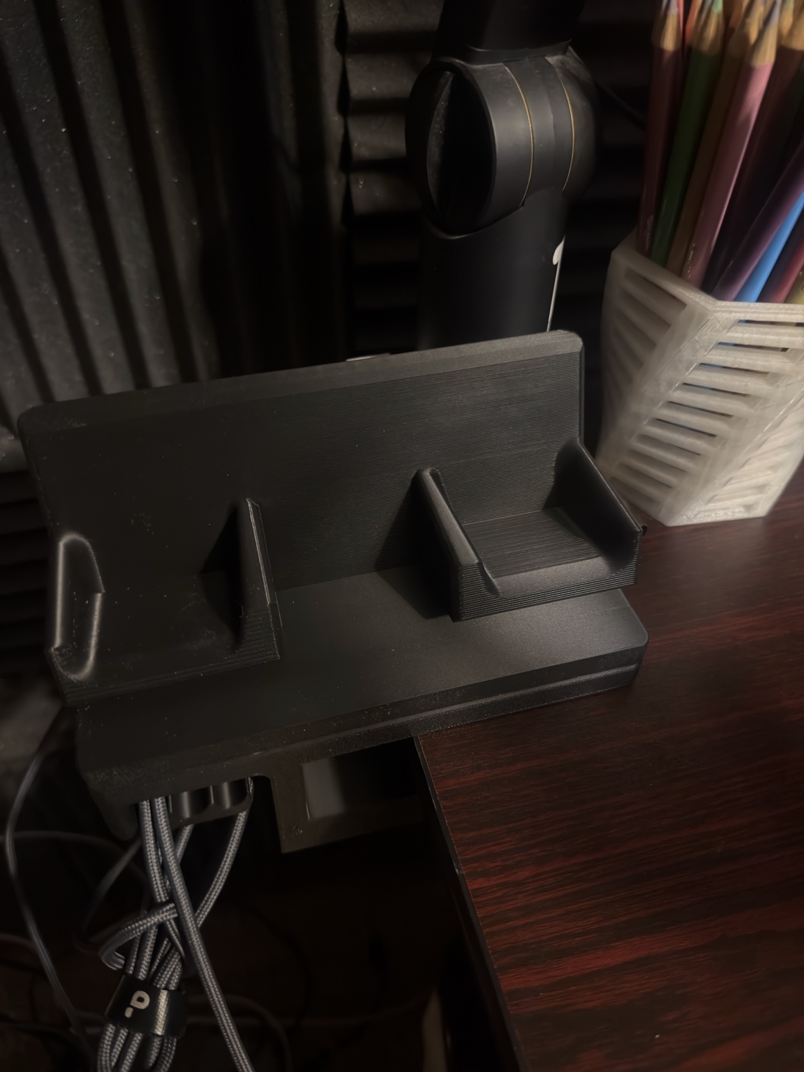 Empty 3D printed desk clamp dock mounted to a desk