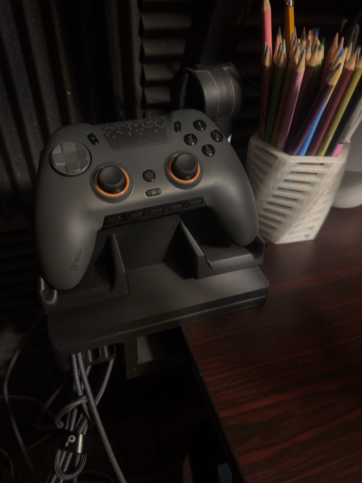 3D printed adjustable desk clamp dock holding a game controller